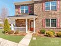 Inviting front porch and entrance to this well-manicured brick home with colorful shutters at 6332 Kennard Dr, Charlotte, NC 28216