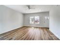 Bright living room featuring laminate floors, fresh white walls, and a ceiling fan for added comfort at 66 Reed Ne St, Concord, NC 28025