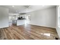 Open-concept living space boasts wood floors and abundant natural light, flowing into the modern kitchen at 66 Reed Ne St, Concord, NC 28025