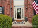 Inviting entrance with brick accents, a stylish door mat and beautiful wreath at 809 Circle Trace Rd, Monroe, NC 28110