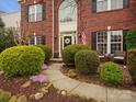 Charming brick home featuring lush landscaping and a welcoming walkway to the front door at 809 Circle Trace Rd, Monroe, NC 28110