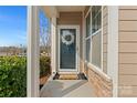 Inviting front porch with a wreath and a decorative 'home' doormat, creating a warm welcome at 919 Pennington Dr, Lancaster, SC 29720