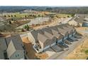 Aerial view of townhomes overlooking a pond and a park with baseball fields at 919 Pennington Dr, Indian Land, SC 29720