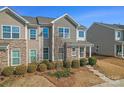 Attractive townhome showcasing a combination of stone and siding accents with manicured landscaping at 919 Pennington Dr, Indian Land, SC 29720
