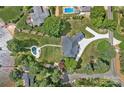 Beautiful aerial view of a luxury home with a pool and lush landscaping in an established neighborhood at 106 Beachview Dr, Mooresville, NC 28117