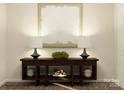 Elegant entryway featuring a stylish console table, lamps, and decorative artwork at 109 Dogwood Grove Pl, Troutman, NC 28166