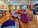 Comfortable and spacious living room with hardwood floors, colorful accents, and natural light at 120 B E Innes St, Salisbury, NC 28144