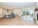 Open-concept living space with a fireplace, large sliding glass doors, and hardwood floors at 1324 Sage Pine Cir, Clover, SC 29710