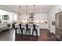 Modern kitchen with a large island, stainless steel appliances, pendant lighting, and white cabinetry at 13306 Old Store Rd, Huntersville, NC 28078