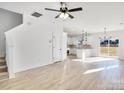 Spacious living room featuring hardwood floors, modern lighting, and an open floor plan at 1540 Solitude Ct, Kannapolis, NC 28081