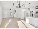 Open-concept living area with modern lighting, stairs, and a doorway to a backyard patio at 1540 Solitude Ct, Kannapolis, NC 28081