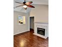 Living room features wood floors, a fireplace, and an archway to the kitchen at 172 Heath Ln, Mooresville, NC 28117