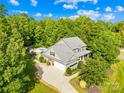 Beautiful two-story home with a well-manicured lawn, lush landscaping, mature trees and an in-ground pool at 174 Logan Crossing Dr, Davidson, NC 28036