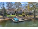 Picturesque waterfront property with a private dock, showcasing serene lake views and beautiful landscaping at 17701 Springwinds Dr, Cornelius, NC 28031