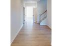 Bright foyer with wood flooring, white walls and trim, and a staircase with white banister at 1812 Augustine St, Monroe, NC 28112