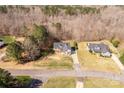 Aerial view of a tan home with a large front yard, surrounded by trees and neighboring properties at 2050 Sunswept Ln, York, SC 29745