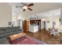 Spacious living room with hardwood floors, ceiling fan, and open layout flowing into the kitchen and dining area at 2050 Sunswept Ln, York, SC 29745