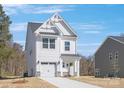 Charming two-story home with a white exterior, well-manicured lawn, and attached garage at 2125 Tom Sadler Rd # 7159, Charlotte, NC 28214