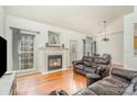 Inviting living room features a cozy fireplace, large window with natural light and hardwood flooring at 227 Spicewood Cir, Troutman, NC 28166