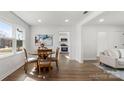 Bright dining area with hardwood floors and a round wooden table near the kitchen and living room at 2509 Lanecrest Dr, Charlotte, NC 28215