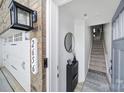 Inviting entryway features an elegant light fixture, modern accents, and staircase to the upper level at 2656 Grantham Place Dr, Fort Mill, SC 29715