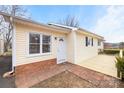 Up close view of the home's front door and deck with stylish color palette at 2687 Glenn St, Newton, NC 28658