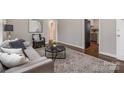 Cozy living room showcasing hardwood floors, comfortable seating, stylish accents, and easy access to other rooms at 3231 Eastwood Dr, Charlotte, NC 28205
