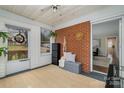 Cozy sunroom featuring brick accent wall and access to both the outdoors and the main house at 3231 Eastwood Dr, Charlotte, NC 28205