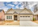 Charming brick home with a two-car garage, manicured lawn, and classic architectural details at 333 Lifestyle Ct, Cramerton, NC 28056