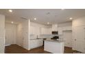 Bright kitchen featuring white cabinets, stainless steel appliances, granite countertops, and a center island at 3427 Secrest Lndg, Monroe, NC 28110