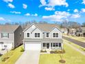 Beautiful two-story home featuring a well-maintained lawn, two-car garage and inviting front porch at 4021 Eckels Dr, Charlotte, NC 28215