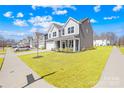 Gorgeous two-story home featuring a well-manicured lawn and an attached two-car garage at 4021 Eckels Dr, Charlotte, NC 28215