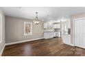 Open dining room with modern chandelier and wood-look floors at 406 E 29Th St, Kannapolis, NC 28083