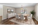 Elegant dining room with a wood table set for six, complemented by a stylish chandelier at 406 E 29Th St, Kannapolis, NC 28083