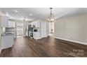 Open kitchen flows into the dining room with wood-look floors at 406 E 29Th St, Kannapolis, NC 28083