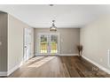 Bright living room with wood-look floors and glass doors leading to the backyard at 406 E 29Th St, Kannapolis, NC 28083