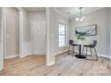 Bright dining area features modern light fixture, wood floors, and fresh neutral paint at 4521 Middlebury Ln, Fort Mill, SC 29715