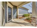 Inviting covered porch featuring stone accents and a stylish front door at 4521 Middlebury Ln, Fort Mill, SC 29715