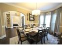 Elegant dining room features a stylish chandelier, large window with curtains, and archway to another room at 4531 Landmark Dr, Rock Hill, SC 29732