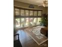 Bright living room with large window, bamboo shades, hardwood floors, and neutral-toned rug at 4805 Nesbit Rd, Monroe, NC 28112