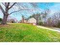Yard view of the property with well-maintained green grass and tall trees at 6142 Gold Creek Estate Dr, Hickory, NC 28601