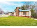 Low angle view of the well-maintained home with beautiful green landscaping at 6142 Gold Creek Estate Dr, Hickory, NC 28601