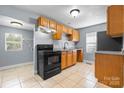 Spacious kitchen featuring tile flooring, a modern stove, and granite countertops at 624 Harris Nw St, Concord, NC 28025