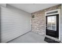 Inviting covered front porch featuring gray brick and siding details at 7006 Everly Commons Ln, Tega Cay, SC 29708