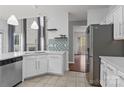 Bright kitchen featuring white cabinets, stainless steel appliances, and a decorative backsplash at 8932 Raven Park Dr, Charlotte, NC 28216