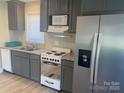 Well-appointed kitchen with modern appliances, granite countertops, and gray cabinets at 920 Oakridge Farm Hwy, Mooresville, NC 28115