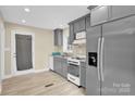 Charming kitchen with grey cabinets, modern appliances, and a door to the outside at 920 Oakridge Farm Hwy, Mooresville, NC 28115