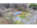 Aerial view of a brick home nestled in a tree-lined neighborhood at 104 Pop Davis Rd, Taylorsville, NC 28681