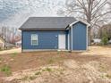 Rear elevation of a blue home with white door and trim surrounded by grass and a large tree at 1137 Williams St, Rock Hill, SC 29732