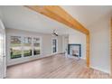 Bright living room with refinished hardwood floors and a fireplace for cozy gatherings at 1200 Grace Ave, Kannapolis, NC 28083